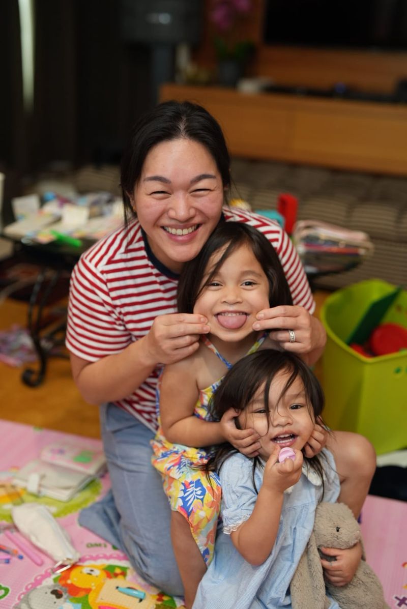 Joann on the floor with Milly and Luna, all three laughing