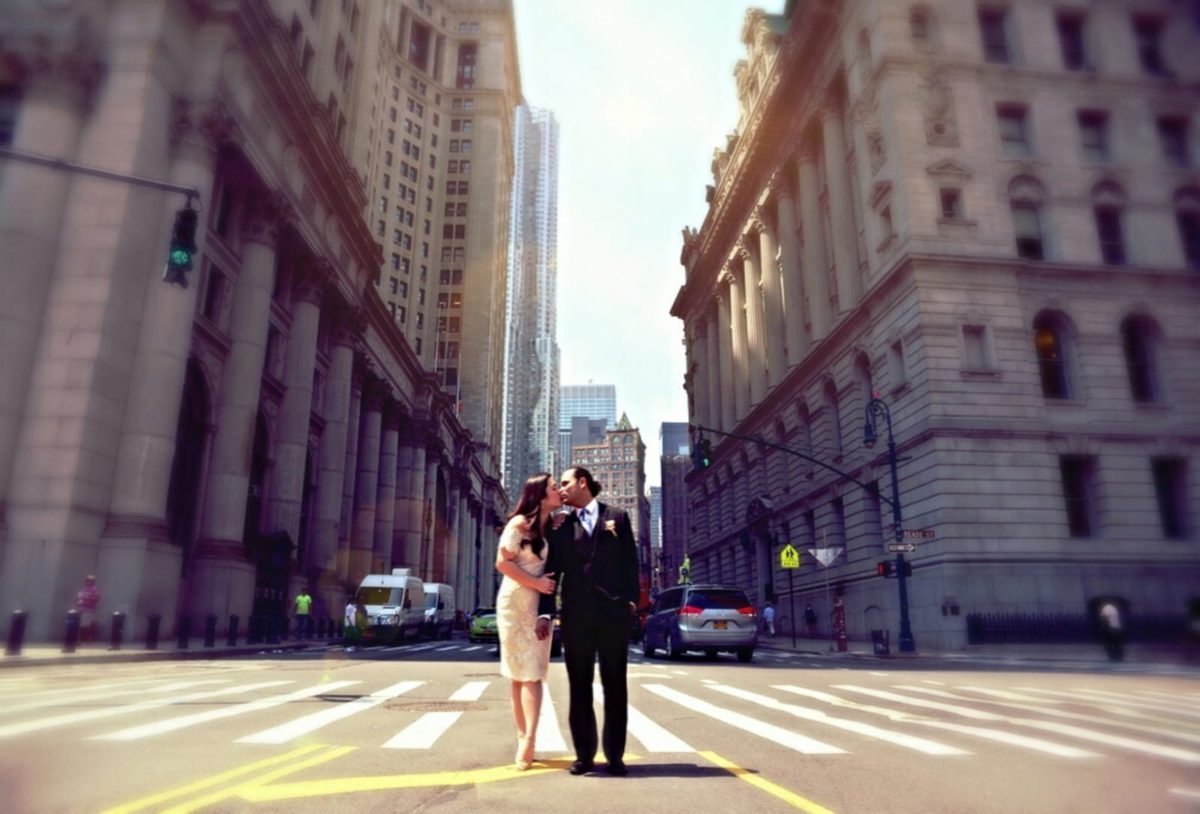 Nery and Joann kissing on an empty Manhattan street on their wedding day