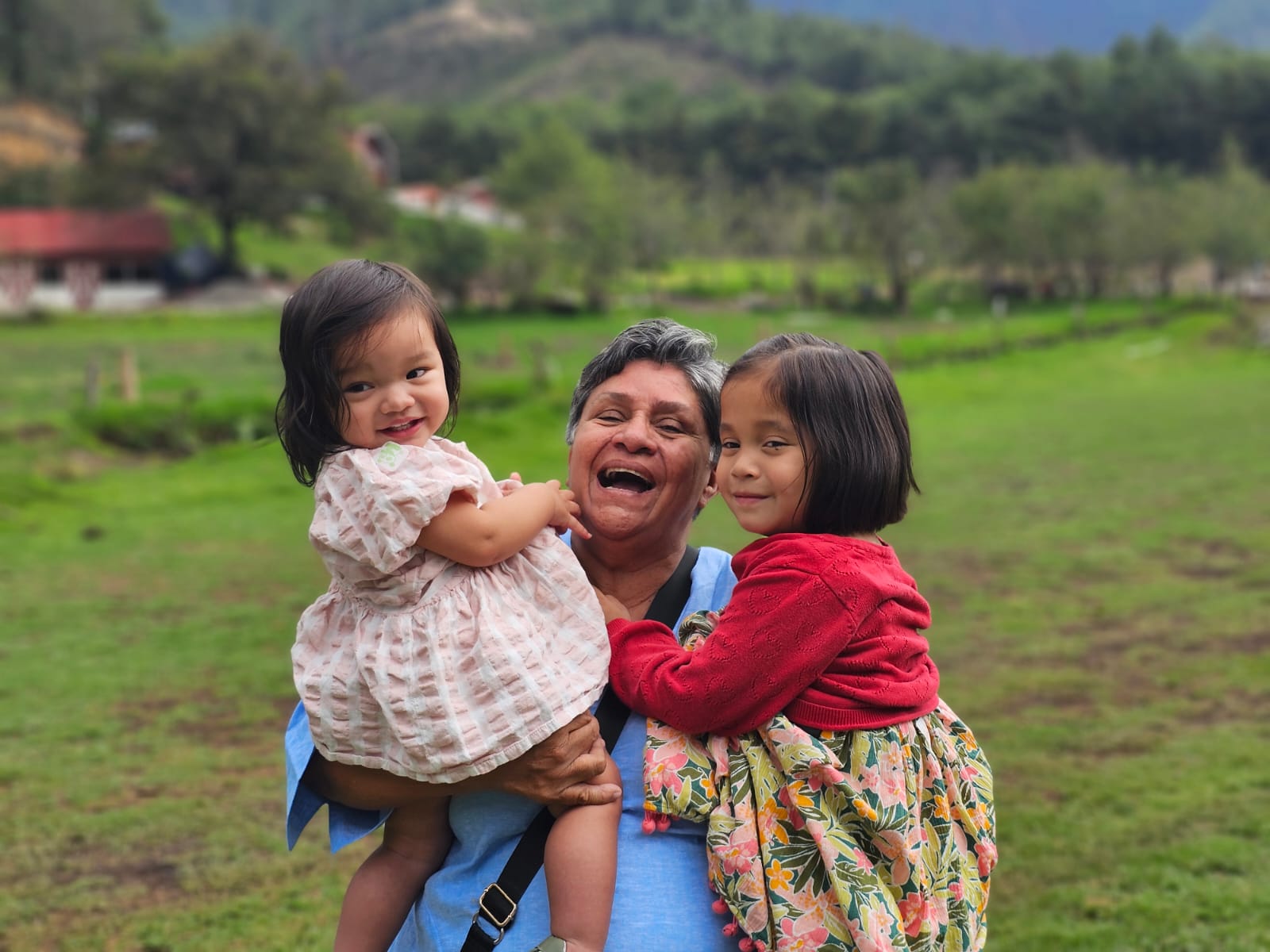 Sandra holding Milly and Luna in the Guatemalan highlands